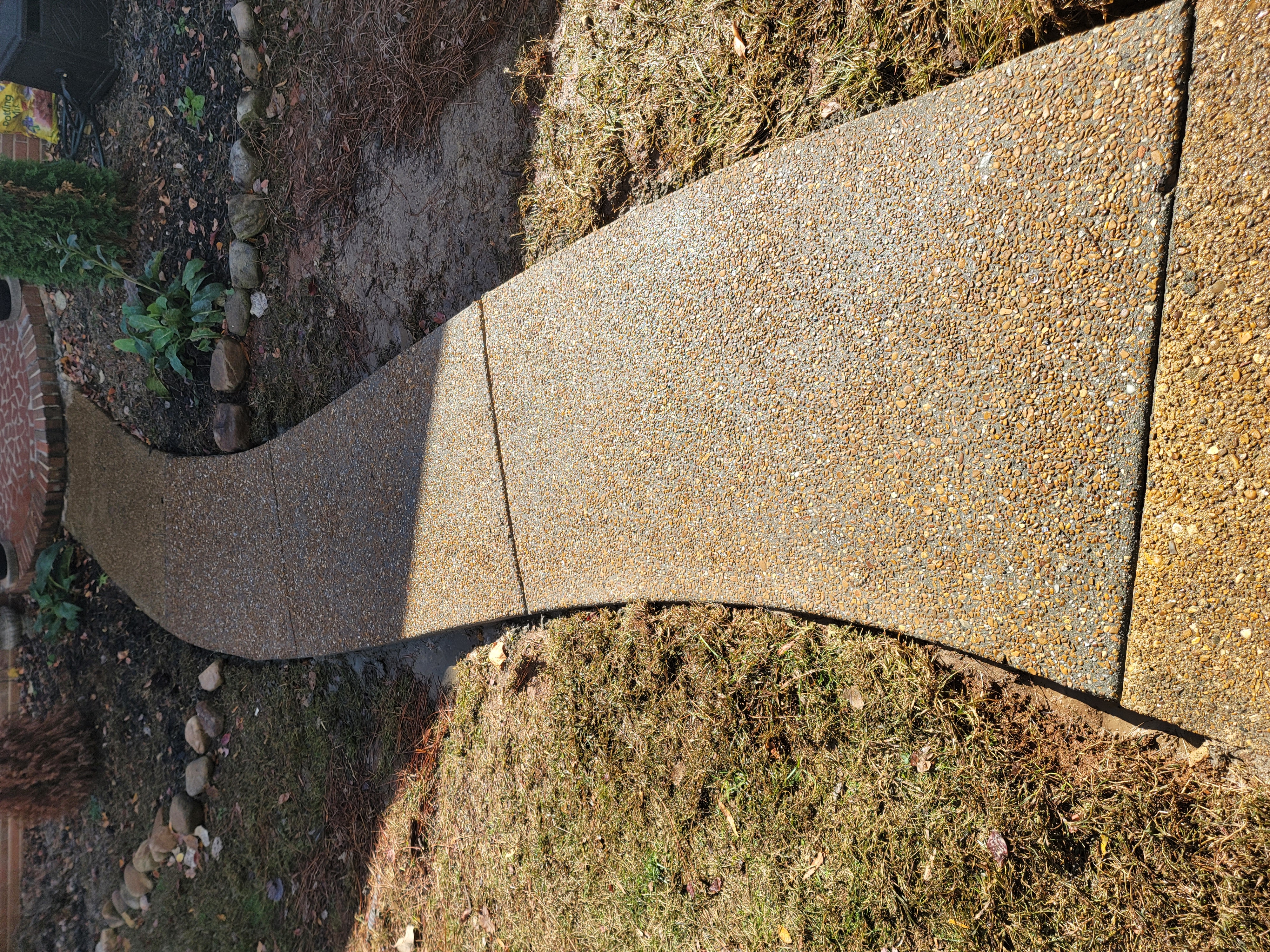 Curved exposed aggregate concrete walkway