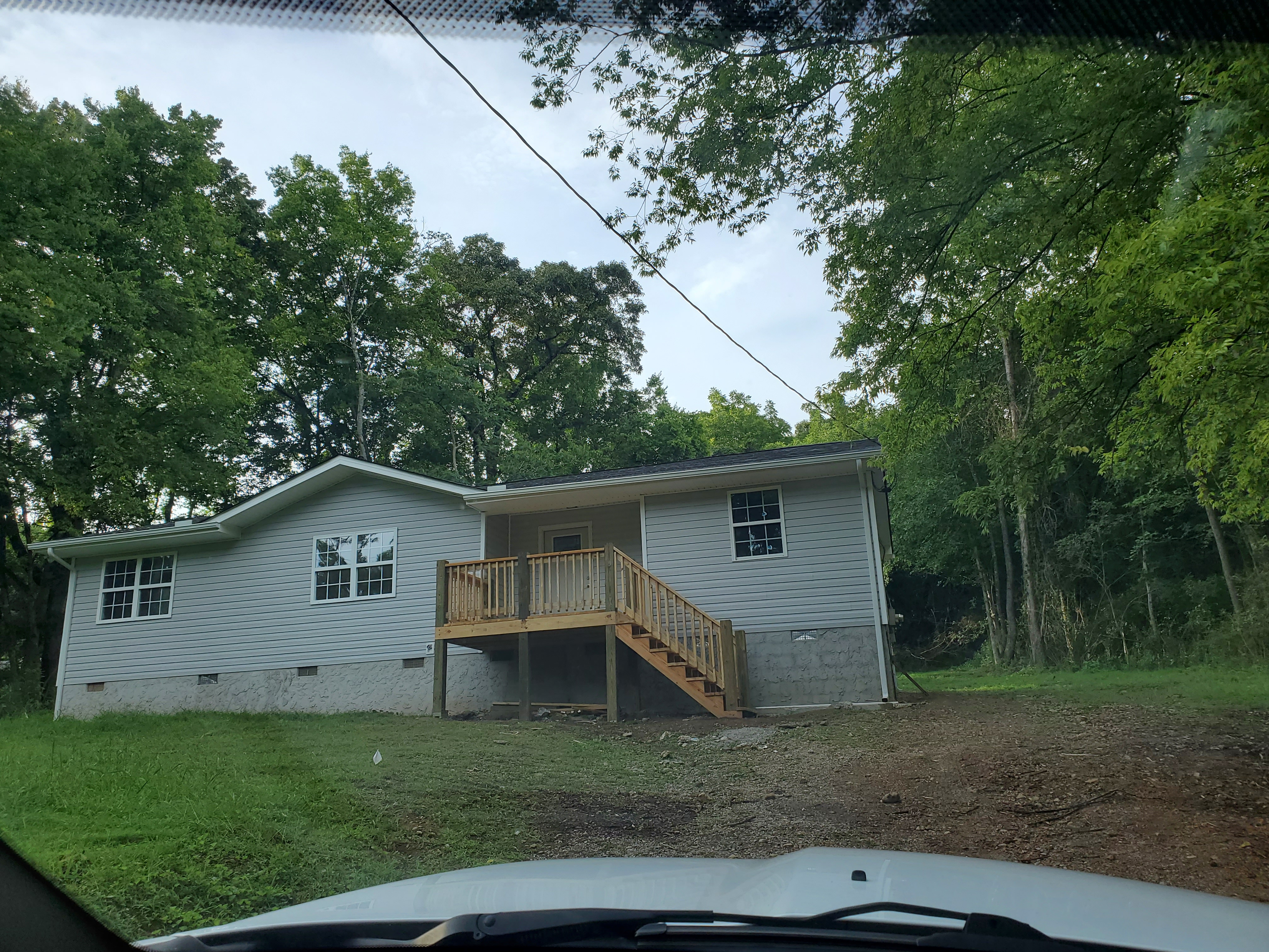 House exterior after remodel - new grey siding and deck