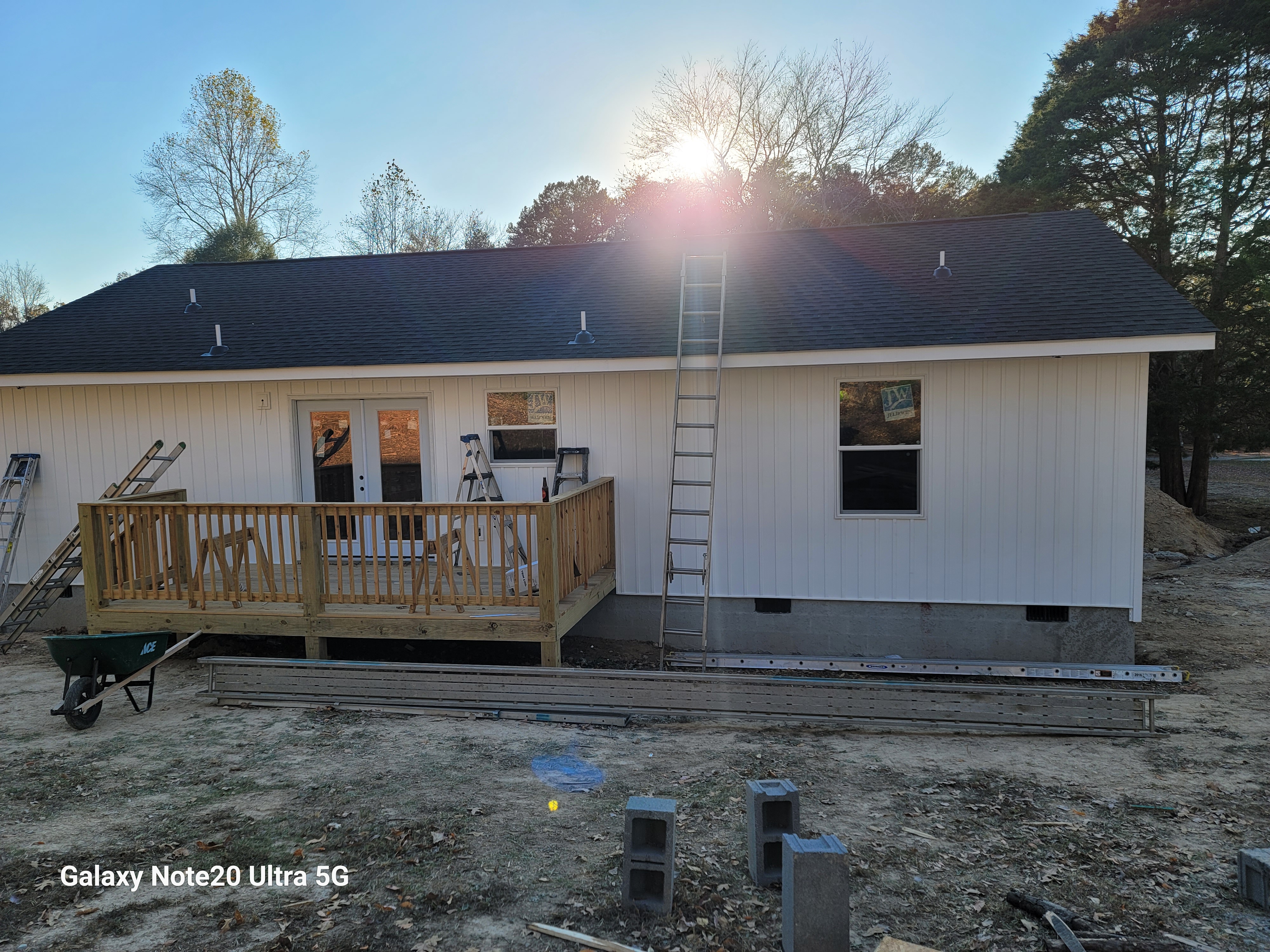 House exterior with white board and batten siding and deck