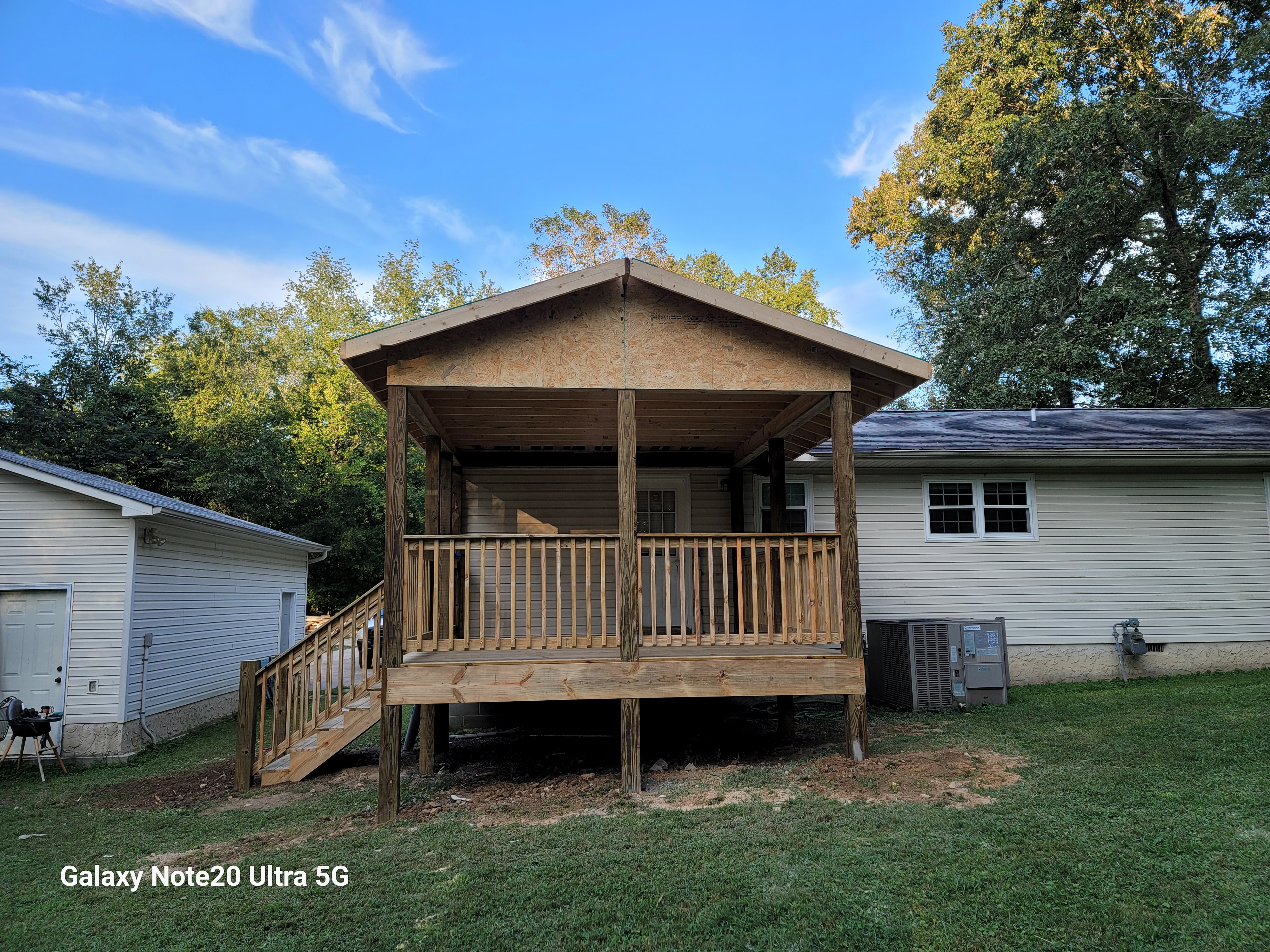 Wide exterior view of covered deck framing