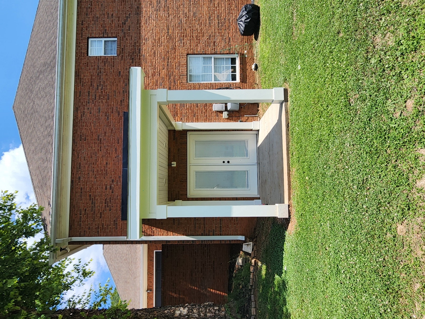 White portico awning on brick exterior
